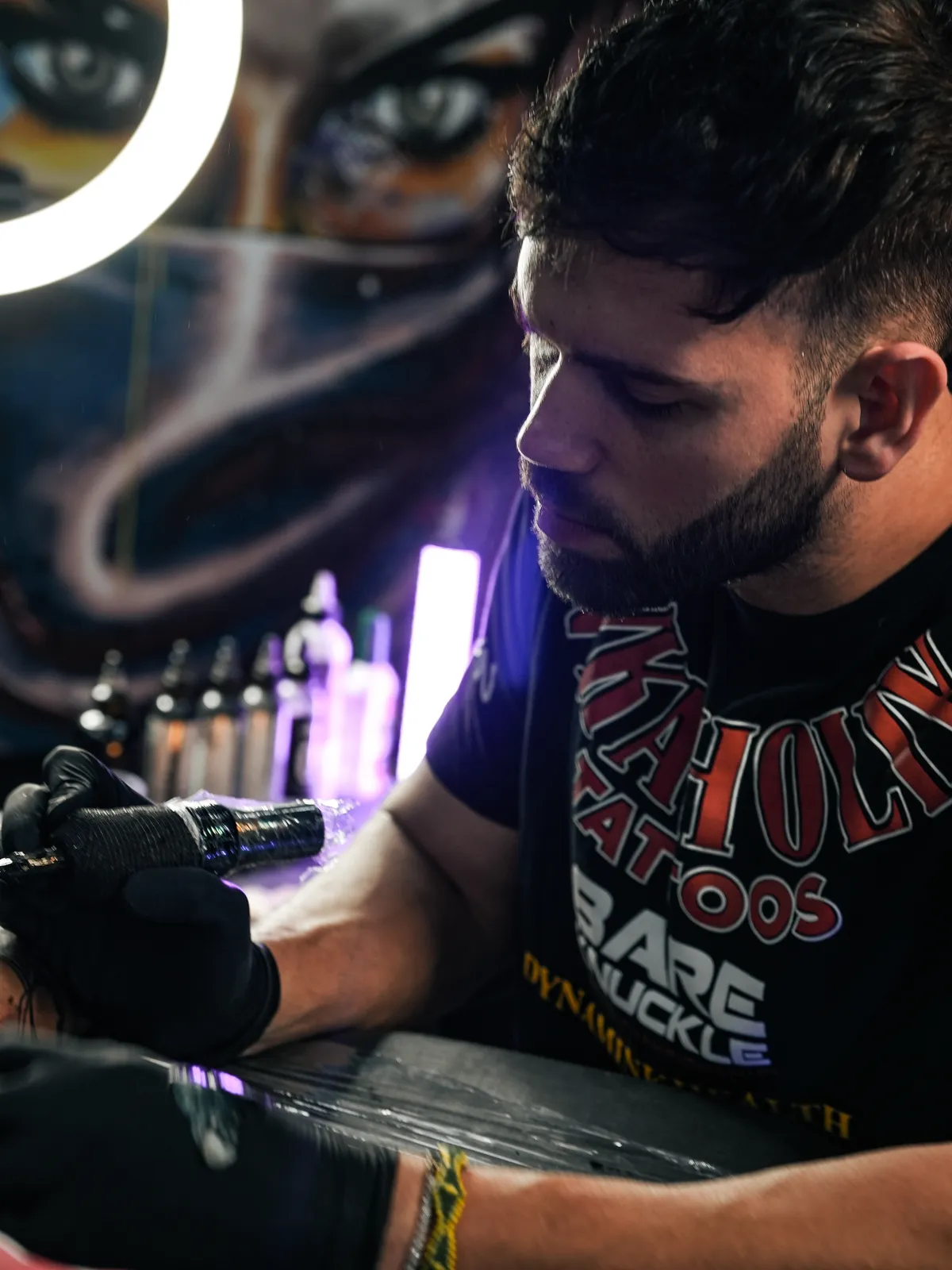 Adán Cruz tattooing in the studio